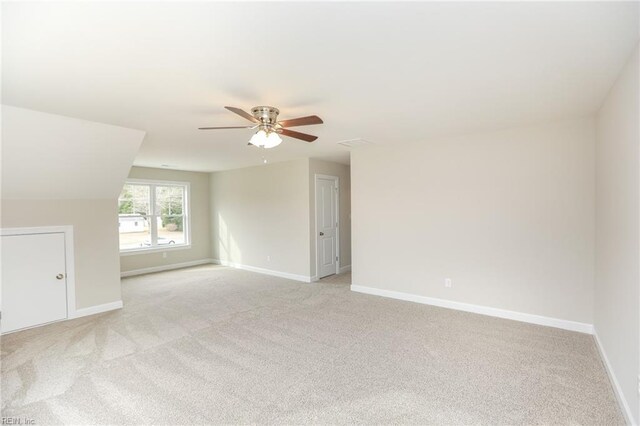 empty room with light colored carpet and ceiling fan