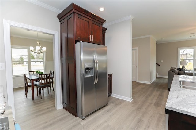 kitchen featuring ornamental molding, a chandelier, and stainless steel fridge with ice dispenser