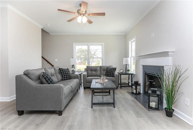 living room featuring crown molding, ceiling fan, and light hardwood / wood-style floors