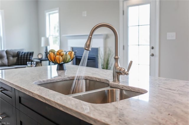 kitchen with light stone countertops and sink