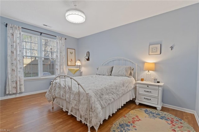 bedroom with wood-type flooring