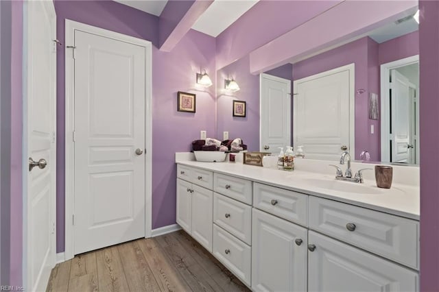 bathroom with vanity and wood-type flooring