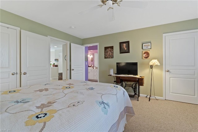 carpeted bedroom with connected bathroom and ceiling fan