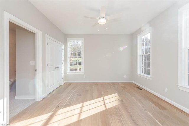 spare room with light hardwood / wood-style flooring and ceiling fan