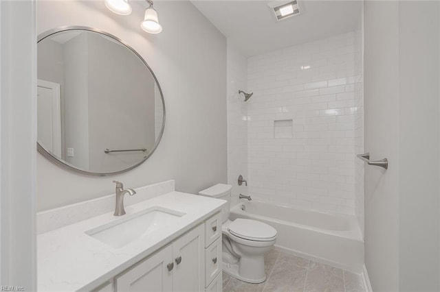 full bathroom with vanity, tiled shower / bath combo, and toilet