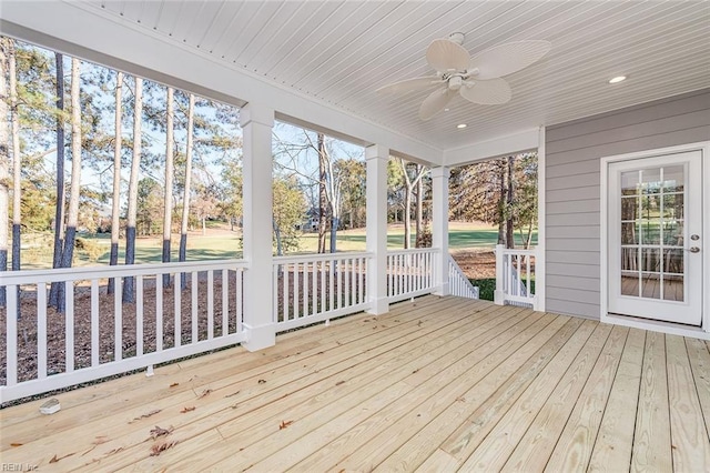 unfurnished sunroom with wood ceiling and ceiling fan