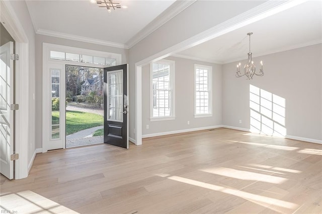 foyer featuring ornamental molding, a notable chandelier, and light hardwood / wood-style flooring