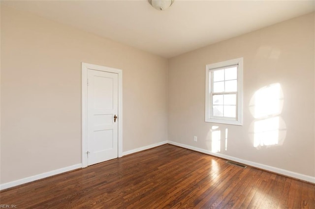 unfurnished room featuring dark hardwood / wood-style flooring