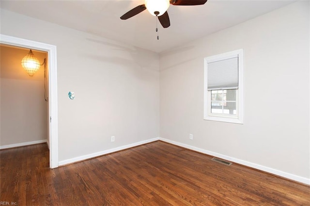 spare room with dark hardwood / wood-style floors and ceiling fan