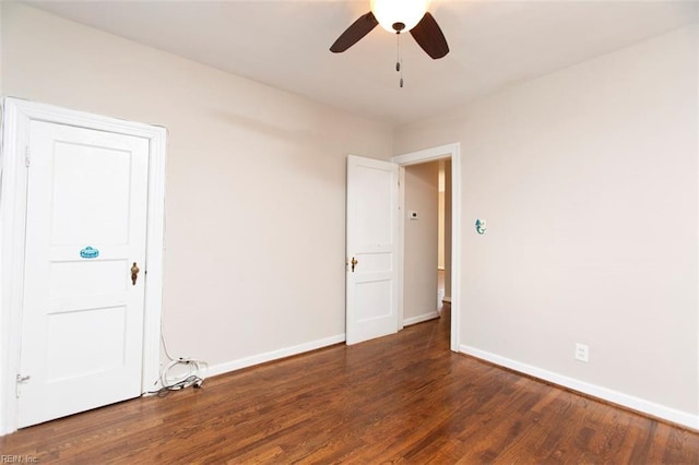 unfurnished room featuring ceiling fan and dark hardwood / wood-style flooring