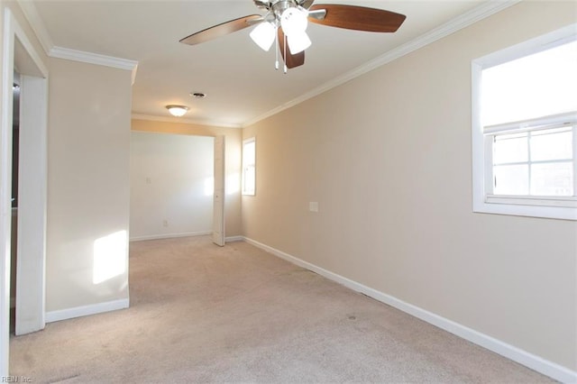 carpeted empty room featuring a wealth of natural light, ornamental molding, and ceiling fan