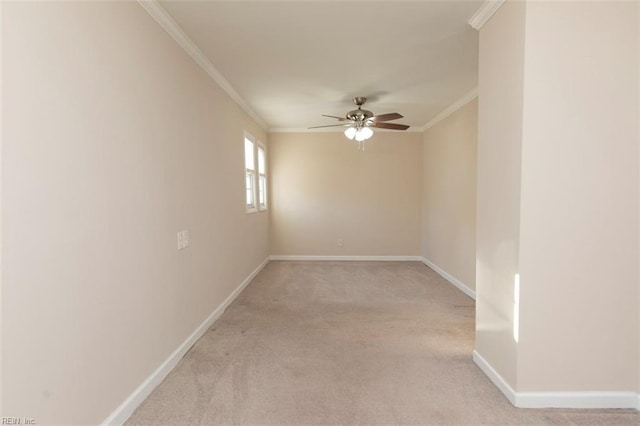 carpeted spare room with ceiling fan and ornamental molding