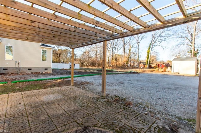 view of patio / terrace with a shed and a pergola