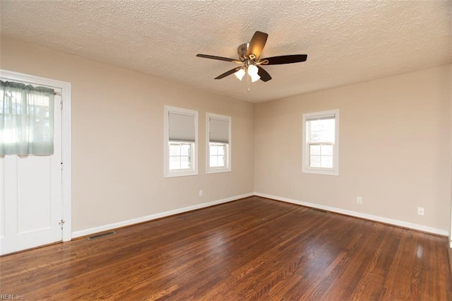 empty room featuring ceiling fan, dark hardwood / wood-style floors, and a textured ceiling