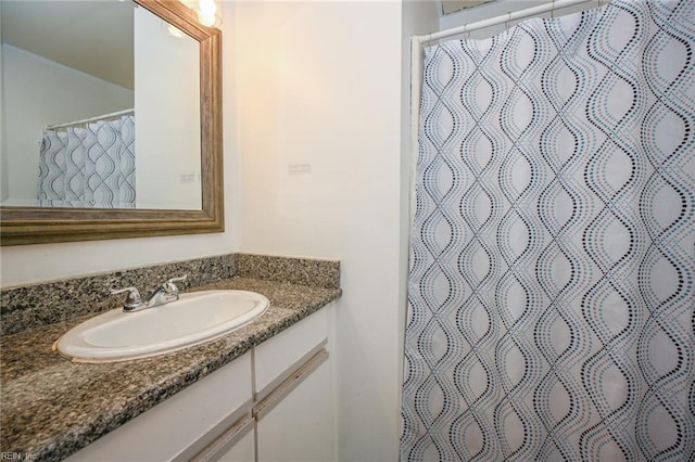 bathroom featuring vanity and a shower with shower curtain