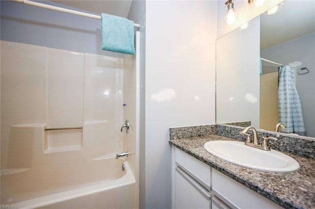 bathroom featuring shower / bath combo and vanity