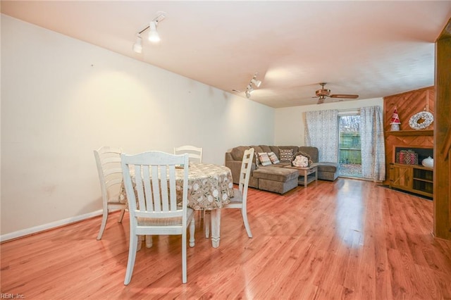 dining area with ceiling fan, track lighting, and light hardwood / wood-style floors