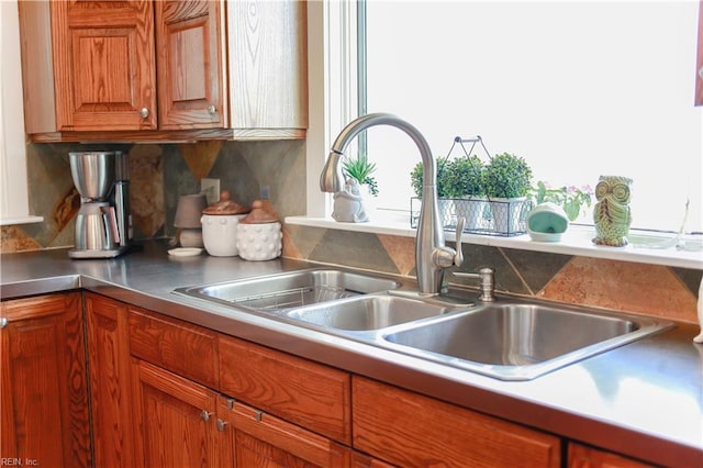 kitchen featuring tasteful backsplash and sink