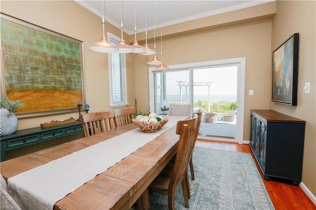 dining space featuring crown molding and hardwood / wood-style floors