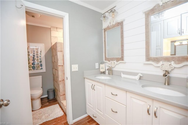 bathroom with wood-type flooring, ornamental molding, vanity, and toilet