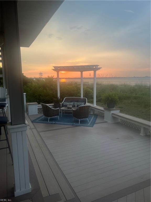 deck at dusk with an outdoor living space