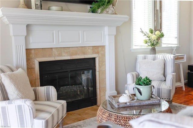 living area with a tiled fireplace