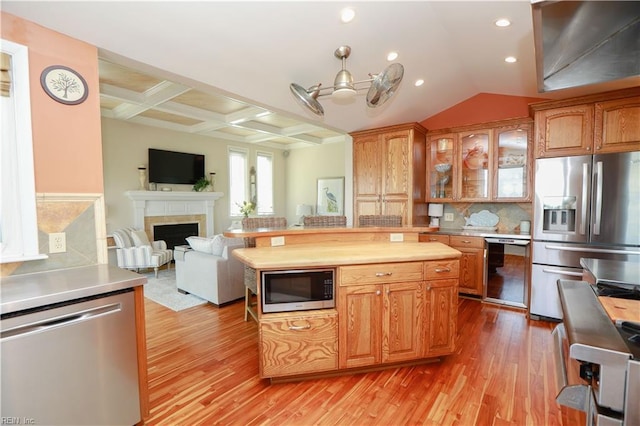 kitchen featuring tasteful backsplash, stainless steel appliances, coffered ceiling, and light hardwood / wood-style flooring