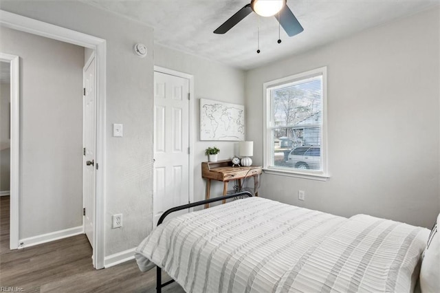 bedroom with ceiling fan and dark hardwood / wood-style flooring