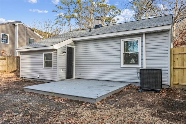 rear view of house featuring a wooden deck and central air condition unit