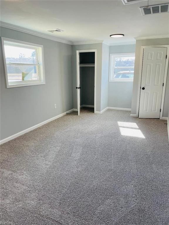 unfurnished bedroom featuring crown molding and light colored carpet