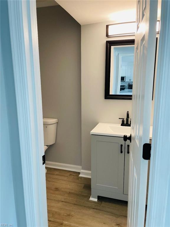 bathroom featuring hardwood / wood-style flooring, vanity, and toilet