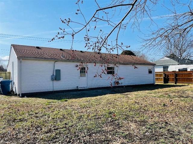 back of property featuring a yard