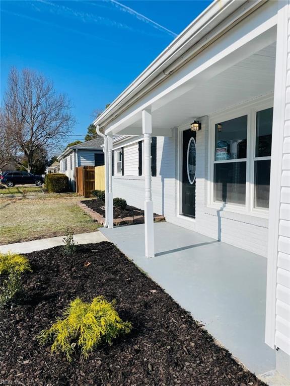 entrance to property with a lawn