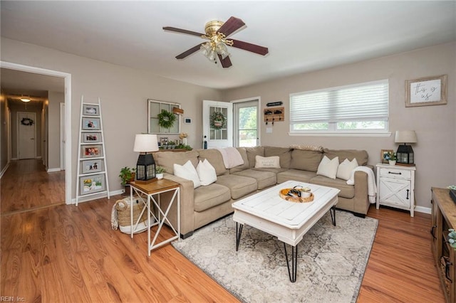 living room featuring hardwood / wood-style floors and ceiling fan