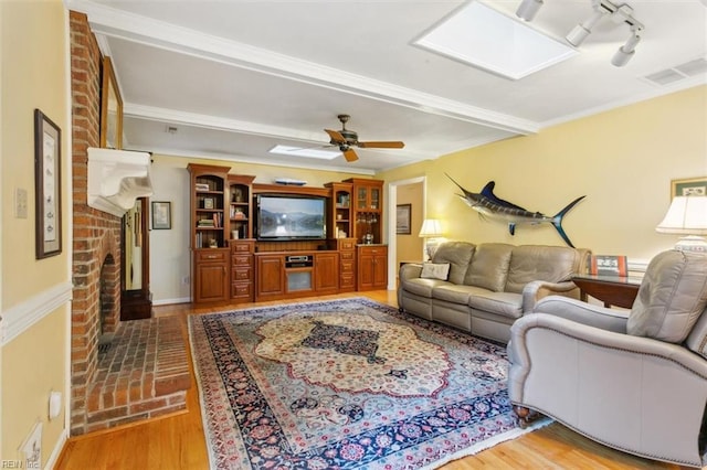 living room with light hardwood / wood-style flooring and ceiling fan