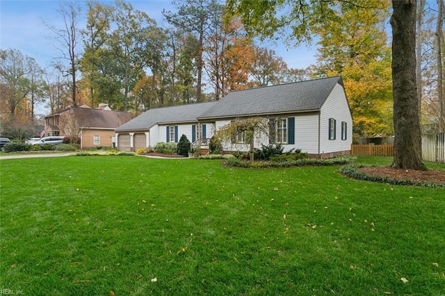 single story home featuring a garage and a front lawn