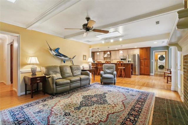 living room with washer / clothes dryer, crown molding, ceiling fan, and light hardwood / wood-style floors