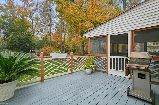 wooden deck with a sunroom