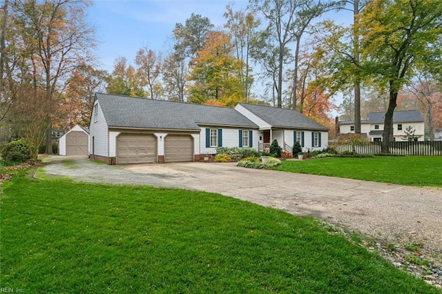 ranch-style home featuring a garage, a storage unit, and a front lawn