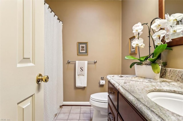 bathroom featuring tile patterned flooring, vanity, and toilet