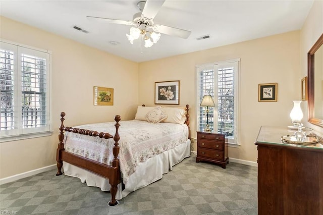 carpeted bedroom featuring multiple windows and ceiling fan