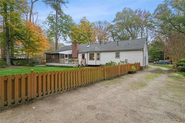 rear view of property featuring a yard