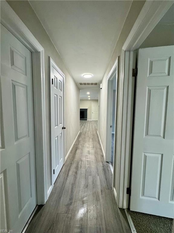 corridor featuring wood-type flooring