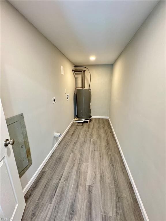 laundry area with water heater, wood-type flooring, and electric dryer hookup