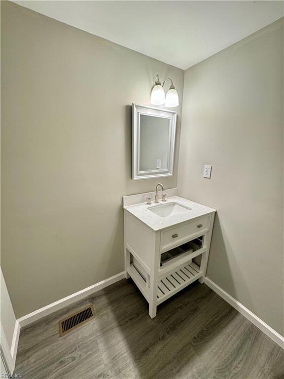 bathroom with hardwood / wood-style flooring and vanity