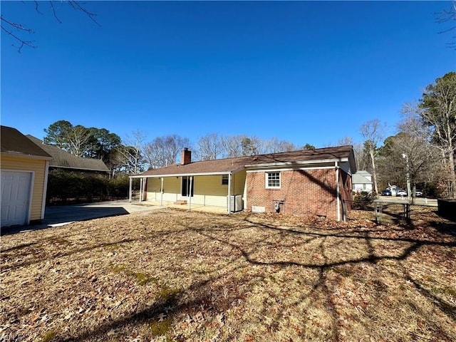 rear view of property featuring a carport