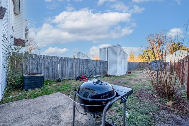 view of yard with a storage shed and a patio area