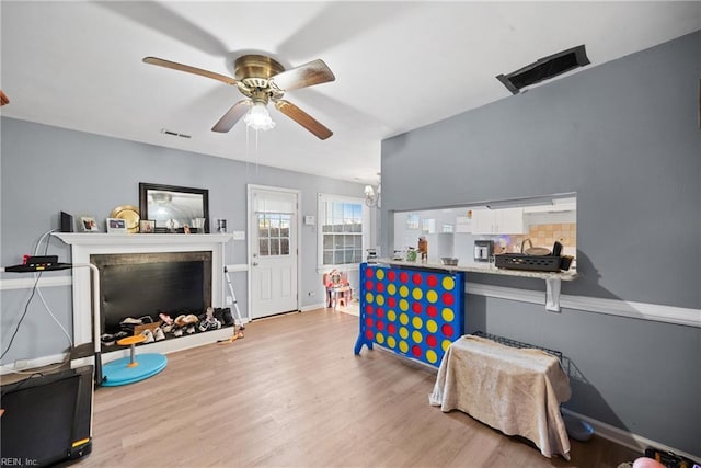 game room with ceiling fan and light hardwood / wood-style flooring