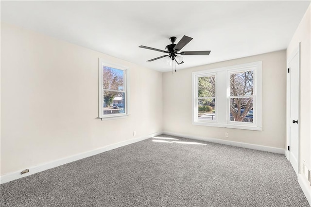 empty room with ceiling fan and carpet floors