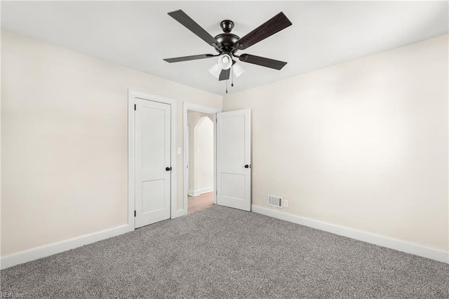 empty room with carpet floors and ceiling fan